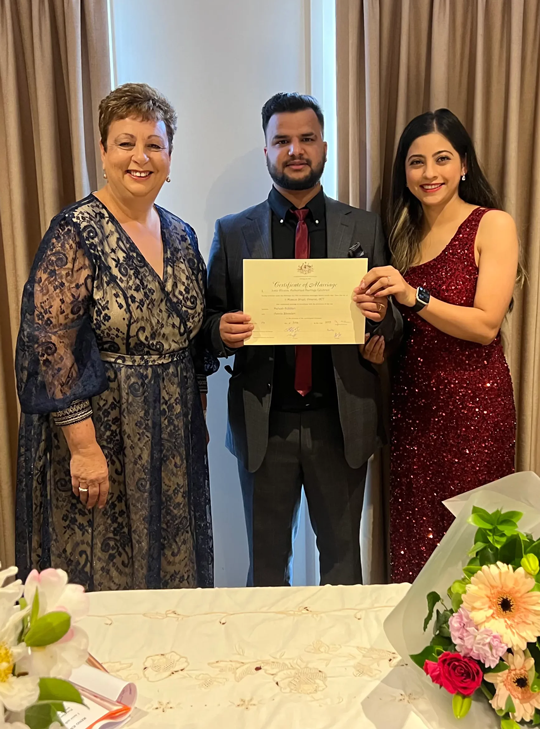 Josie with a couple and their certificate