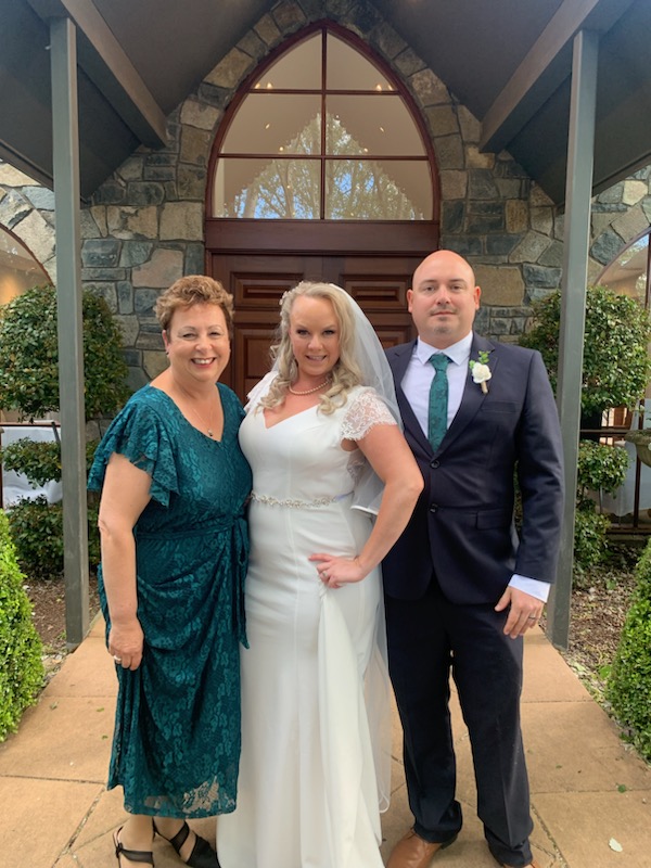 Josie with a bride and groom